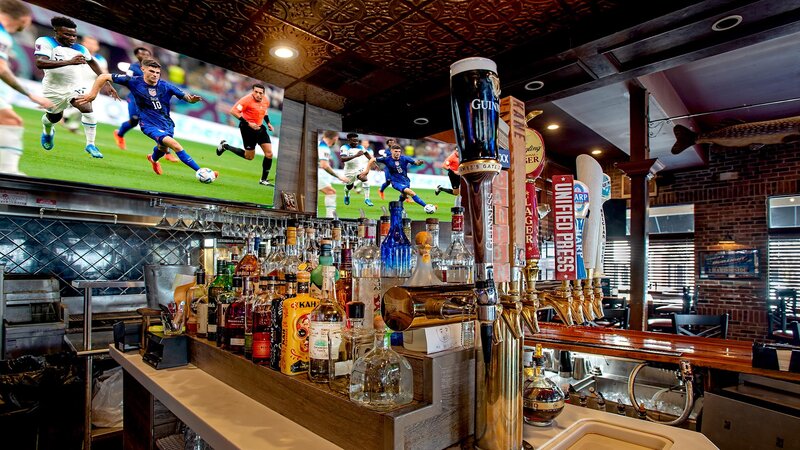 View of bar with liquor bottles and beer taps