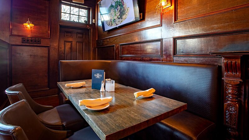 Booth seating in dining room with table set for four